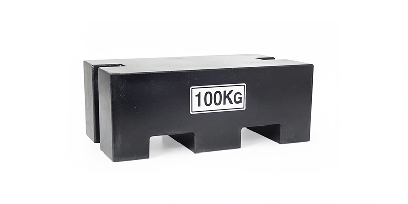 A black counterweight with 100kg printed on it