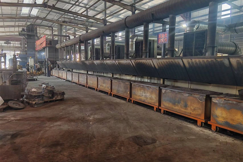 A factory interior filled with various machines and equipment for producing metal castings