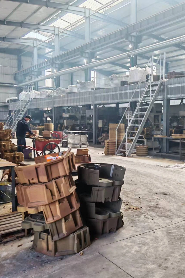A factory scene featuring a man working on boxes related to sand casting