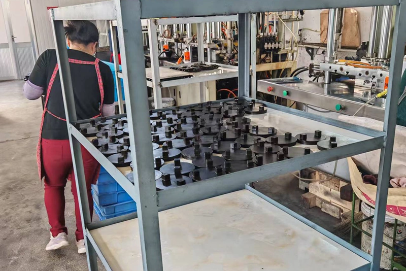 in a factory, a woman uses various tools to create wax patterns, demonstrating skilled craftsmanship