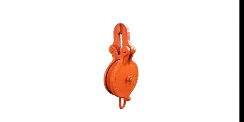 Close-up of a large snatch block, showcasing its robust design and functional features