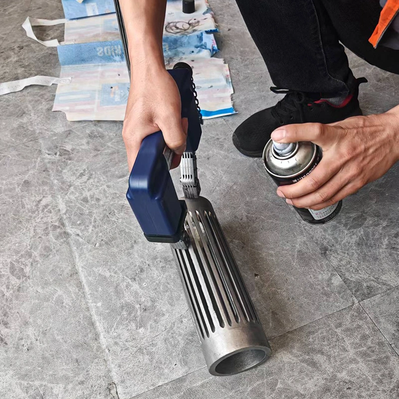 A person using a spray gun to clean the steel casting product, promoting a complimentary testing service for effective cleaning solutions
