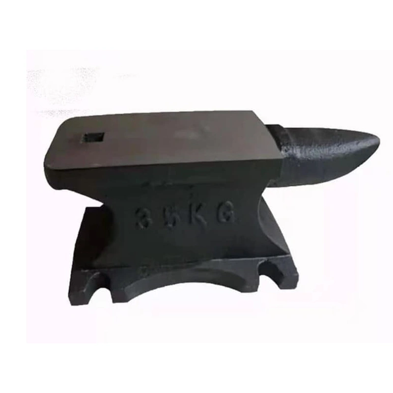 A black anvil resting on top of a larger iron anvil, showcasing the contrast between the two materials